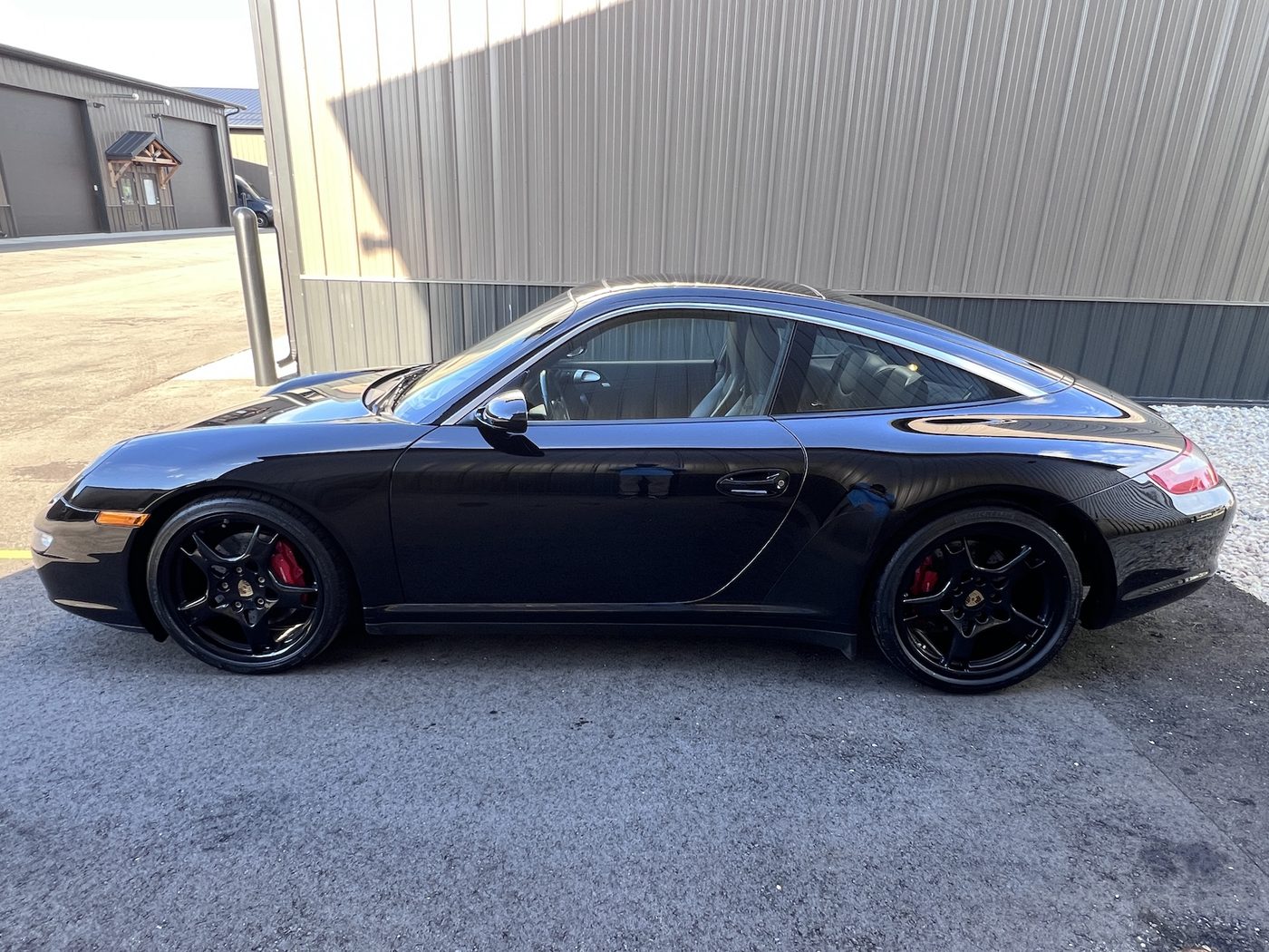 2007 Porsche 911 Targa 4S, black, beside the showroom