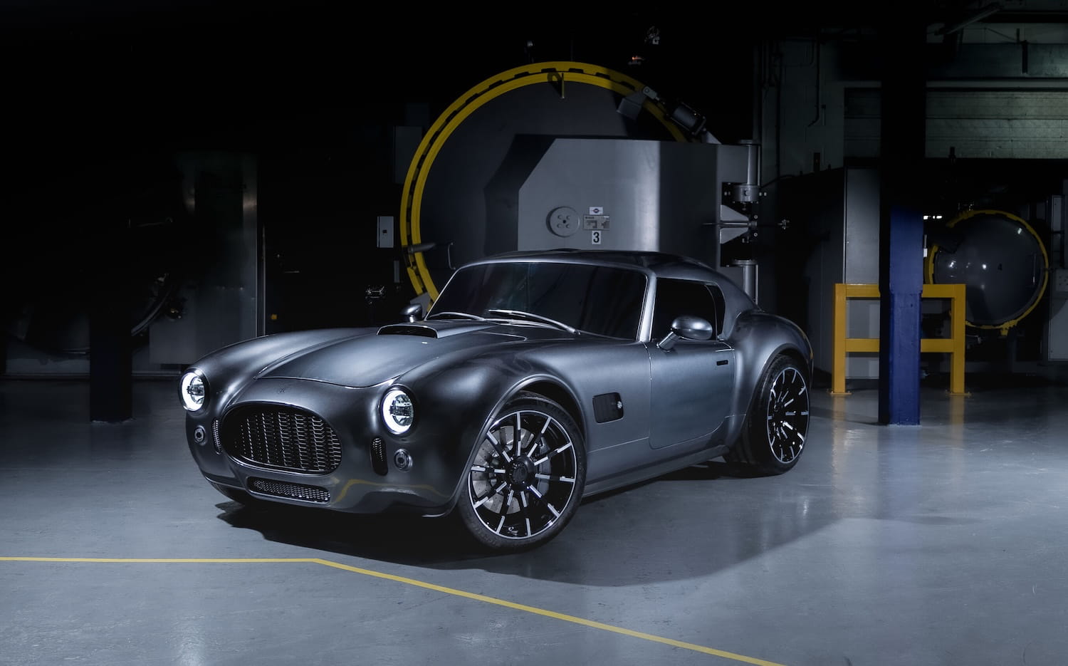 The production AC Cobra GT coupe, front three-quarters in the factory