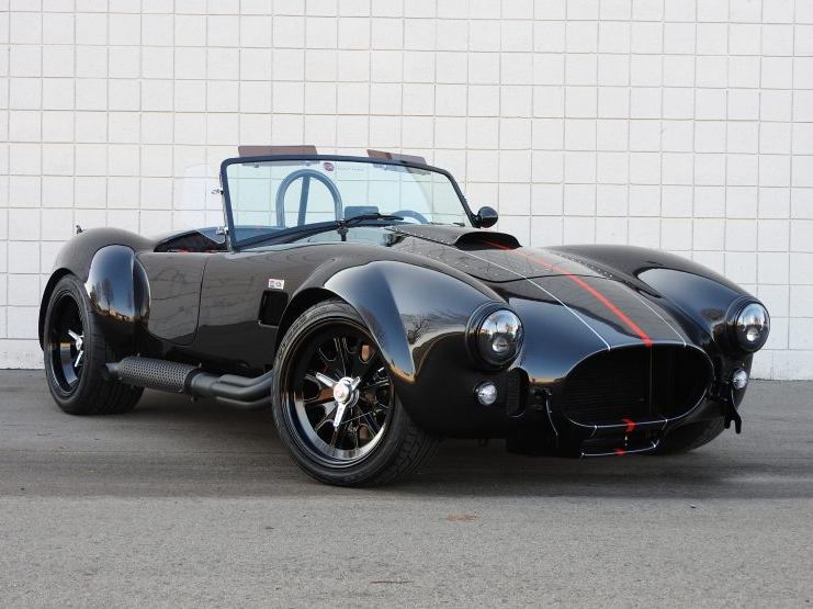 Black Cobra roadster with a red pinstripe
