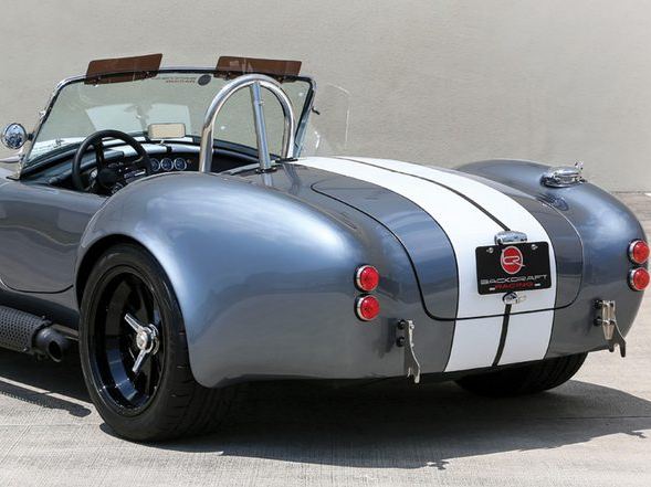 Grey Cobra roadster with white stripes