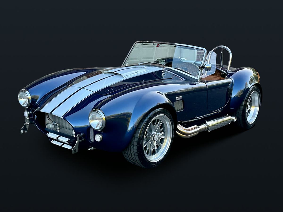 Navy Cobra roadster with white stripes and polished side pipes
