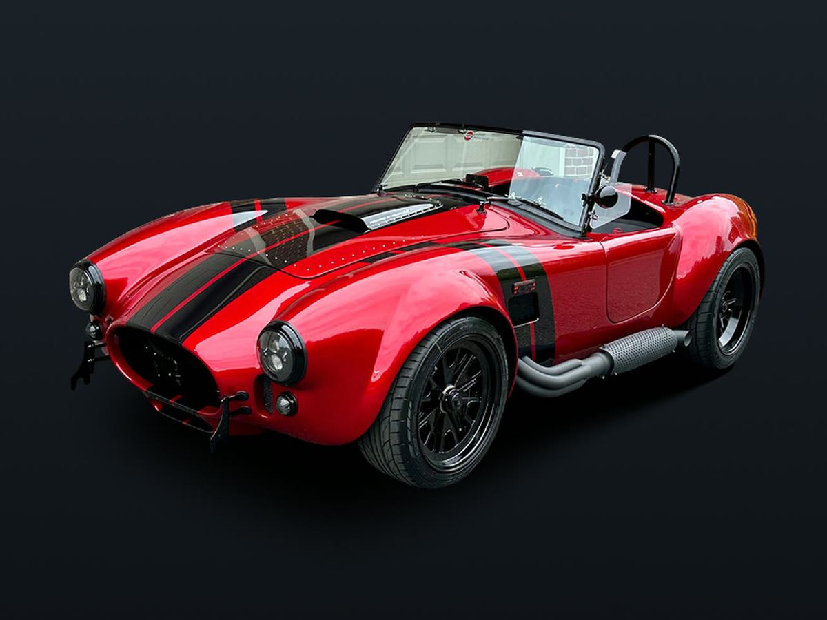 Red Cobra roadster with black stripes, blacked-out pipes and wheels